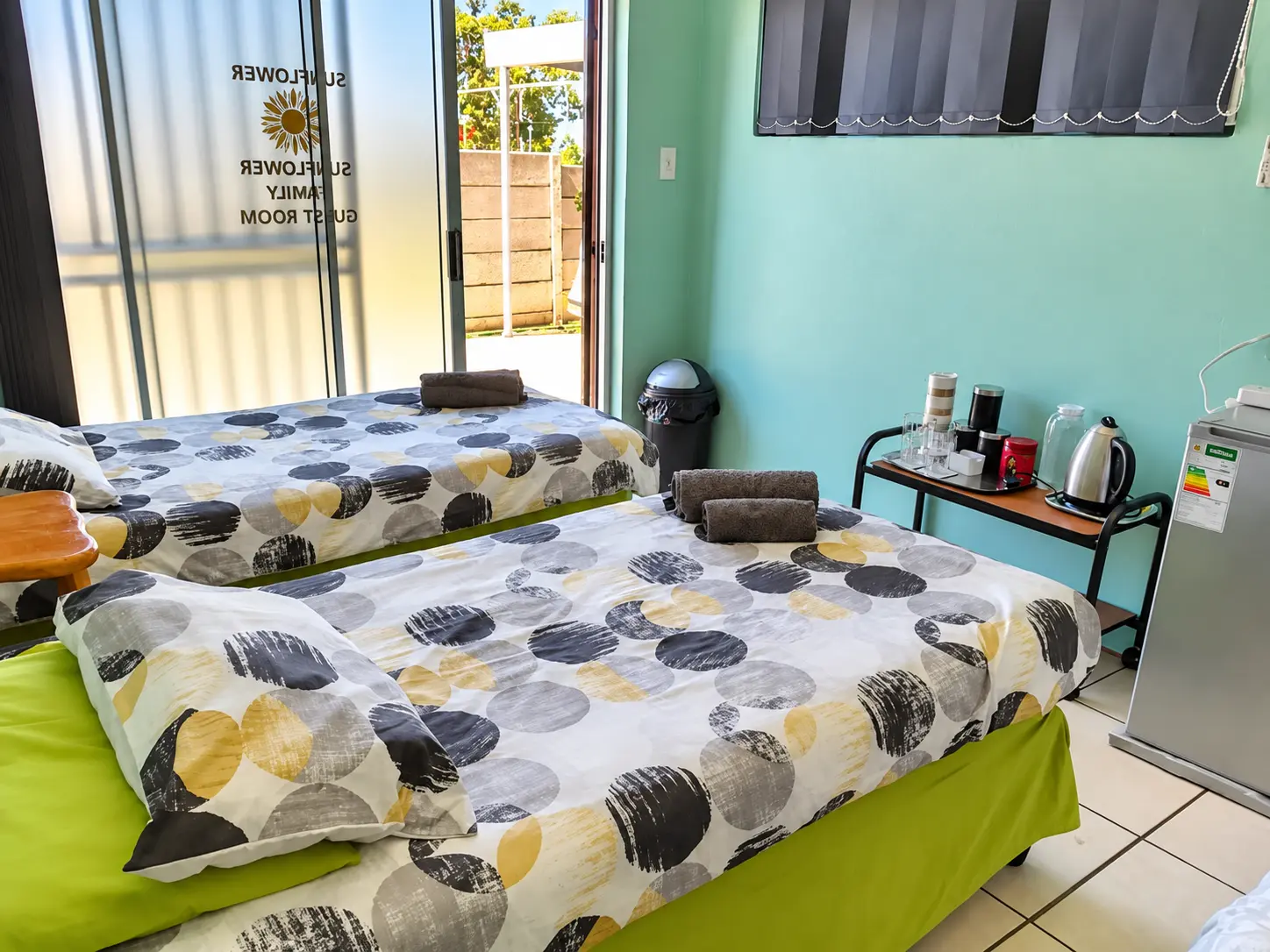 Twin beds with striped duvets in the Sunflower family room