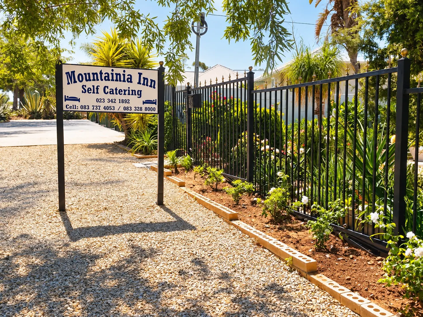 Mountainia Inn entrance sign beside the gravel driveway